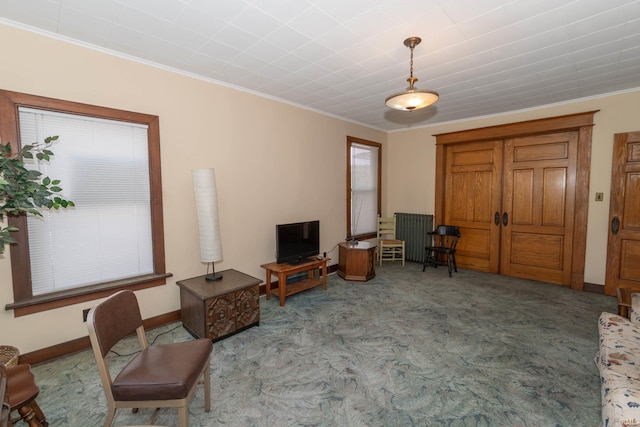bedroom with ornamental molding, radiator heating unit, and ceiling fan