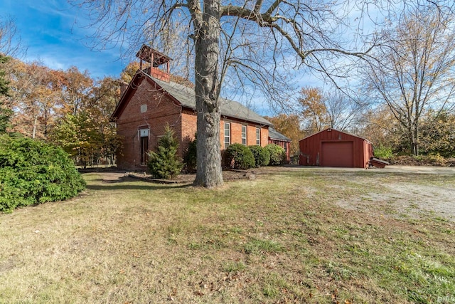 view of side of property featuring an outbuilding, a yard, and a garage