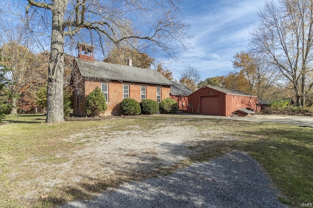 8126 Coldwater Rd, Fort Wayne, IN 46825 - view of side of property with brick siding, a detached garage, an outbuilding, and driveway