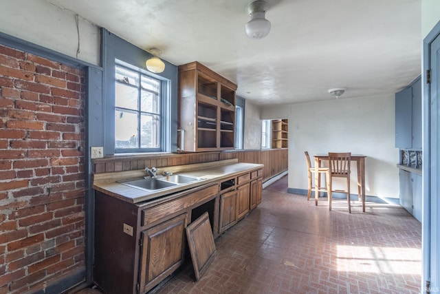 8126 Coldwater Rd, Fort Wayne, IN 46825 - kitchen featuring a sink, brick patterned floors, open shelves, and light countertops