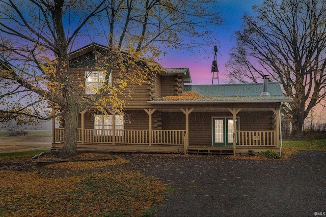 log home featuring covered porch