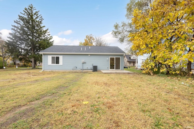 rear view of house featuring a patio area, a yard, and cooling unit