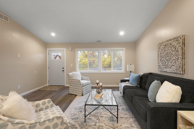 living room with wood-type flooring and vaulted ceiling