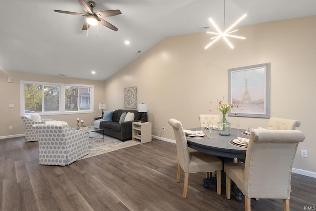 dining room with lofted ceiling, dark hardwood / wood-style flooring, and ceiling fan with notable chandelier