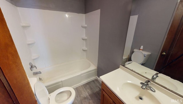 full bathroom with toilet, hardwood / wood-style floors, vanity, and shower / bathtub combination