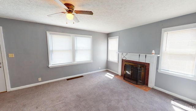 unfurnished living room with light carpet, a textured ceiling, a fireplace, and ceiling fan