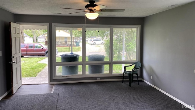 doorway to outside featuring ceiling fan, hardwood / wood-style flooring, and a textured ceiling