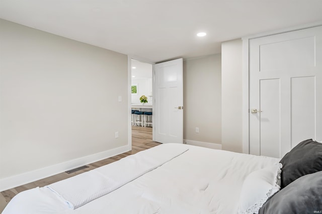 bedroom with hardwood / wood-style flooring