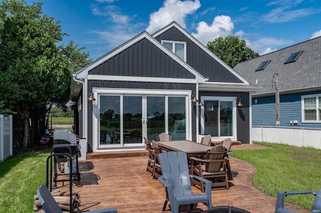 back of house with a patio area and a yard