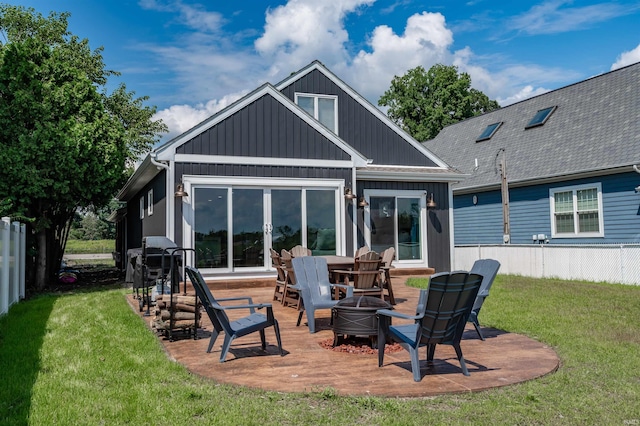 back of property featuring a yard and a patio area