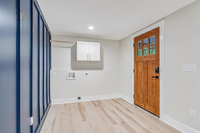 clothes washing area with light hardwood / wood-style floors, hookup for a washing machine, cabinets, and electric dryer hookup