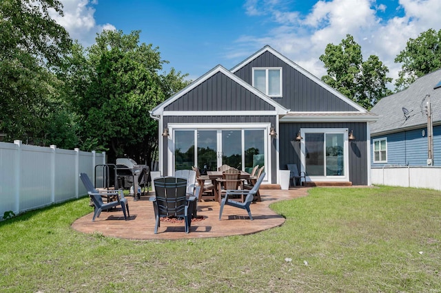 back of house with a yard and a patio