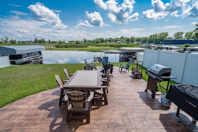 view of patio with grilling area and a water view