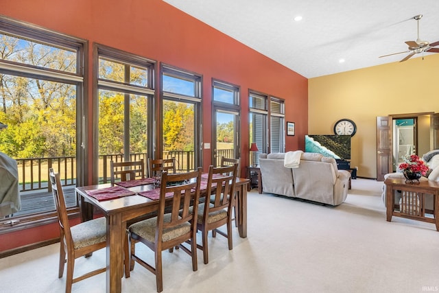 carpeted dining area featuring ceiling fan and a wealth of natural light