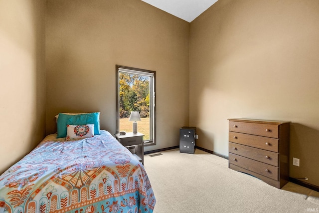 bedroom with light carpet and vaulted ceiling