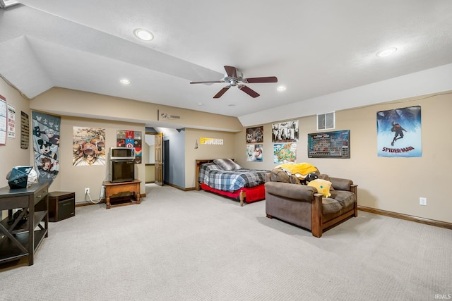 bedroom with ceiling fan, vaulted ceiling, and carpet floors