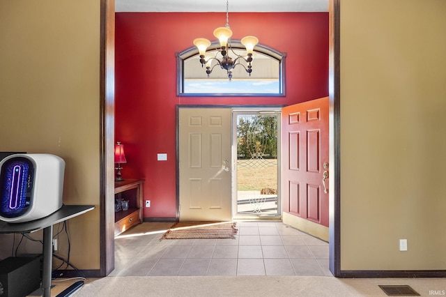 foyer entrance with a notable chandelier, light tile patterned flooring, and a high ceiling