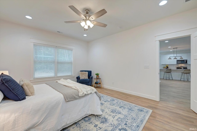 bedroom featuring hardwood / wood-style floors and ceiling fan