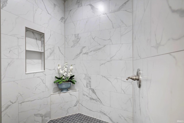 bathroom with tiled shower