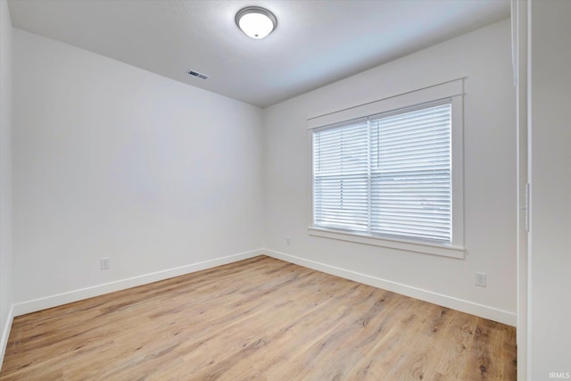 spare room with light hardwood / wood-style flooring