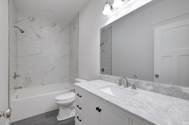 full bathroom with tiled shower / bath, vanity, toilet, and tile patterned floors