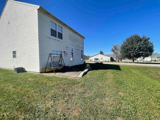 rear view of property featuring a yard