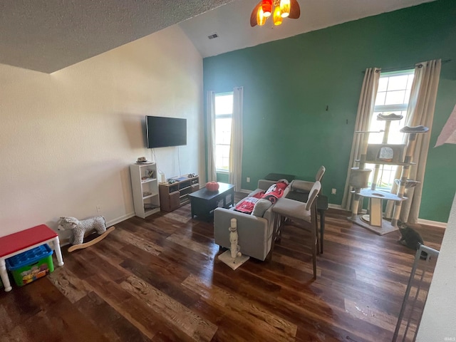 living room featuring ceiling fan, a textured ceiling, vaulted ceiling, and dark hardwood / wood-style flooring