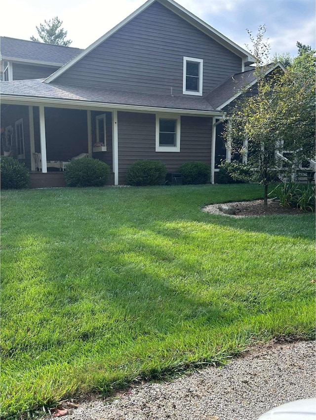 view of side of home featuring a yard