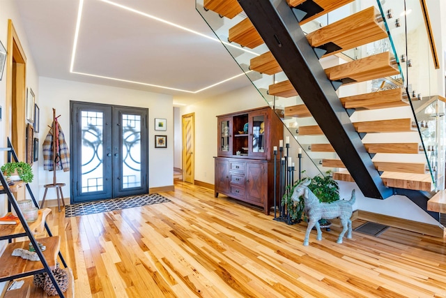 entrance foyer featuring french doors and light hardwood / wood-style flooring