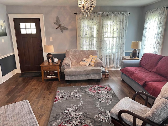 living room with an inviting chandelier and dark hardwood / wood-style floors