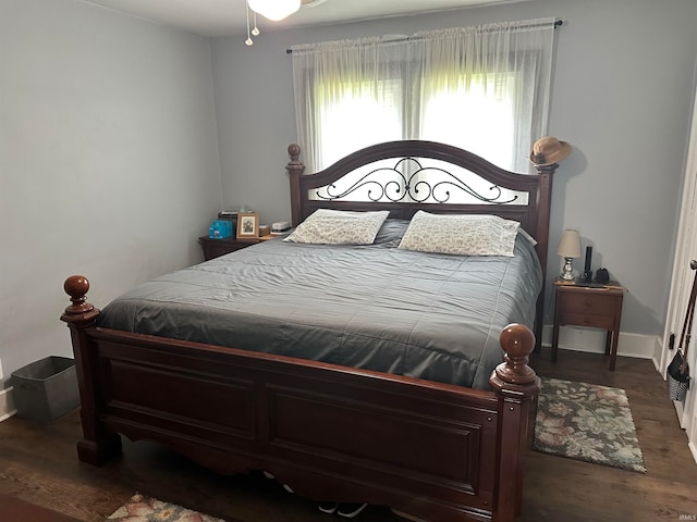 bedroom with dark wood-type flooring