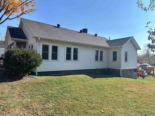 view of property exterior with a lawn