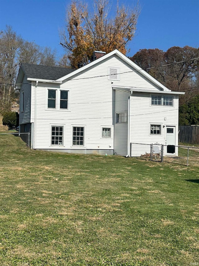 back of property featuring a yard