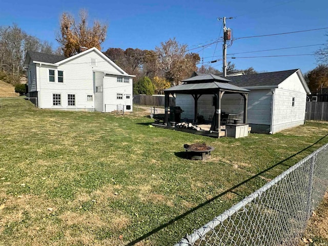 view of yard with a gazebo and a fire pit