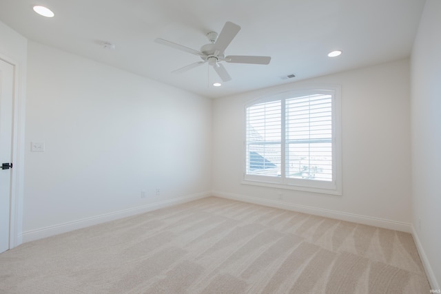 empty room featuring light colored carpet and ceiling fan