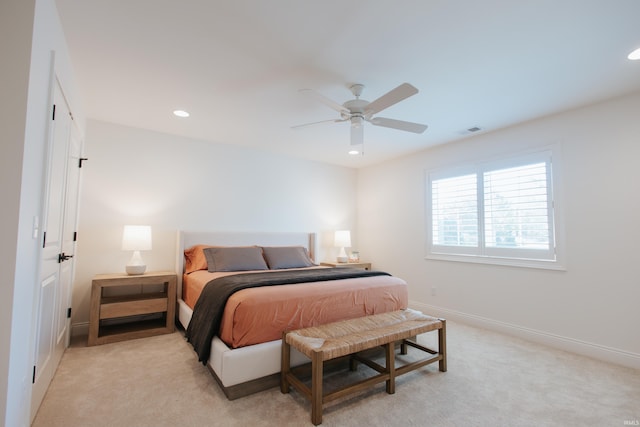 bedroom with ceiling fan and light colored carpet