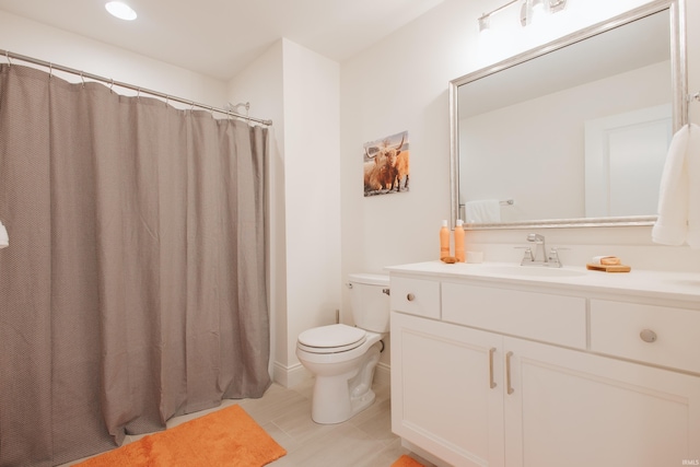 bathroom featuring vanity, toilet, and walk in shower