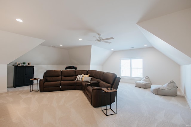 carpeted living room with ceiling fan and lofted ceiling