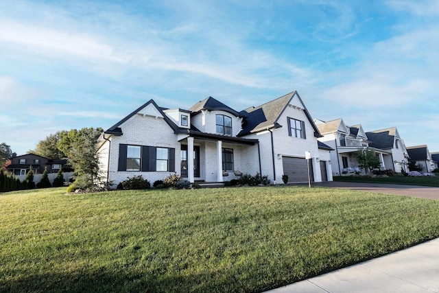 view of front of property featuring a front lawn and a garage