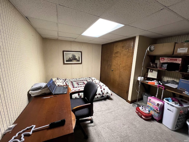 carpeted office featuring a paneled ceiling