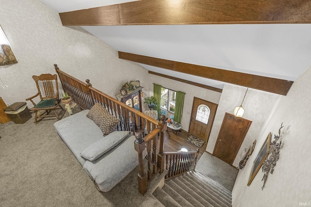 interior space featuring beamed ceiling and carpet flooring