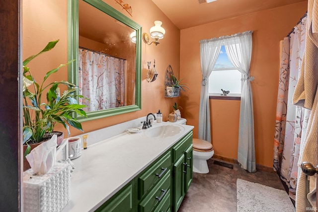 bathroom featuring tile patterned floors, vanity, and toilet