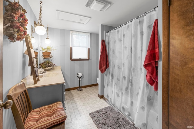 bathroom featuring vanity, toilet, and walk in shower