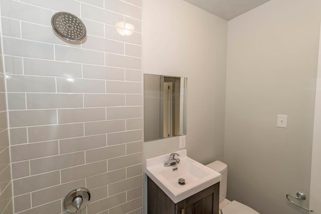 bathroom with vanity, toilet, and a textured ceiling