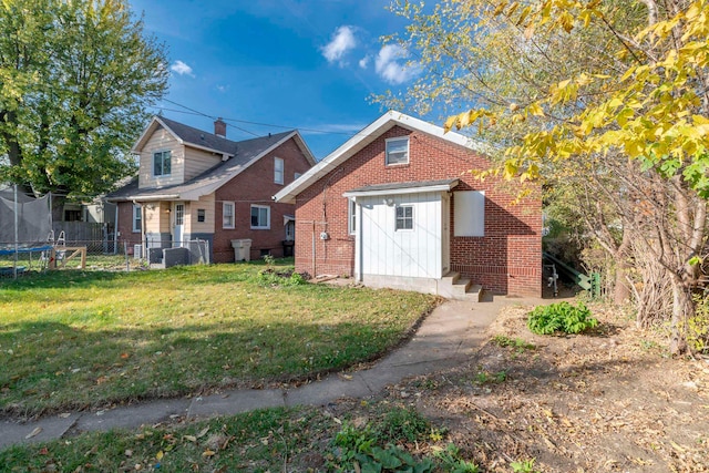 view of front of house featuring a front yard, cooling unit, and a trampoline