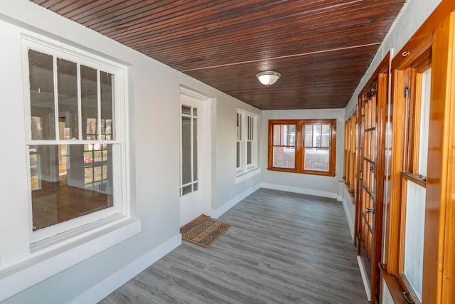 unfurnished sunroom with wooden ceiling