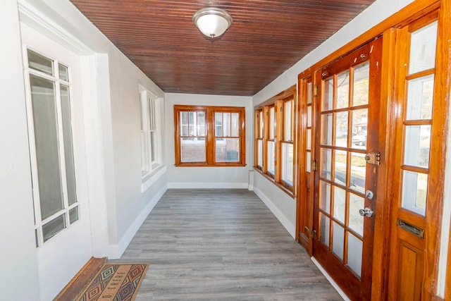 unfurnished sunroom featuring wood ceiling