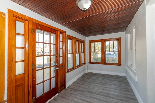 unfurnished sunroom with wooden ceiling and a wealth of natural light