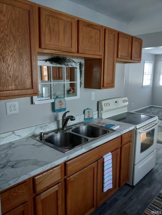 kitchen with white electric range, dark hardwood / wood-style flooring, and sink