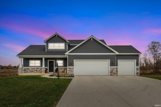 craftsman-style house featuring a yard and a garage